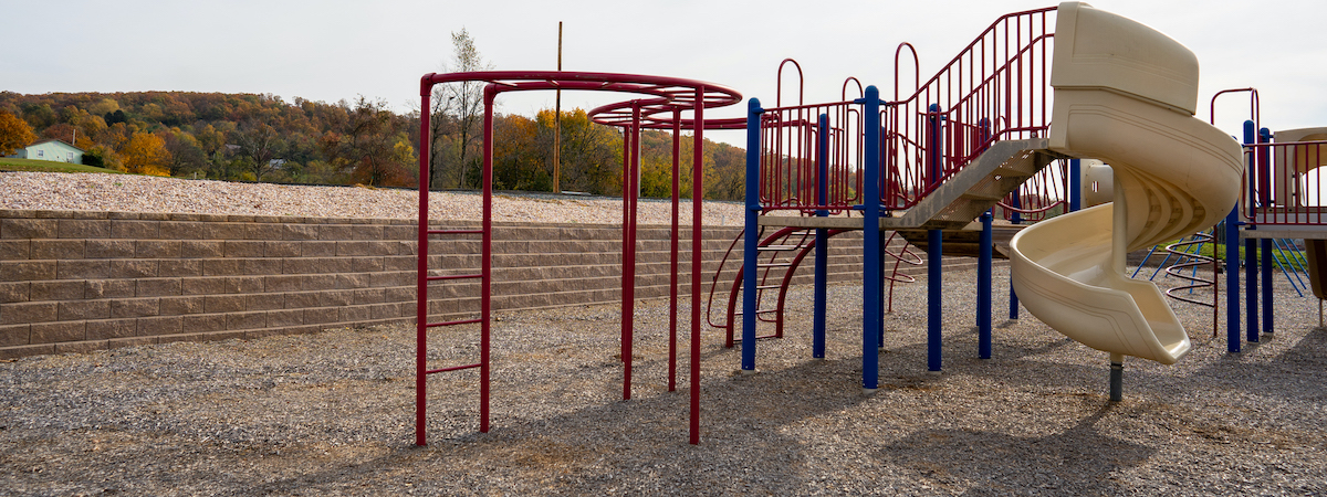 Playground with an Allen Block retaining wall.
